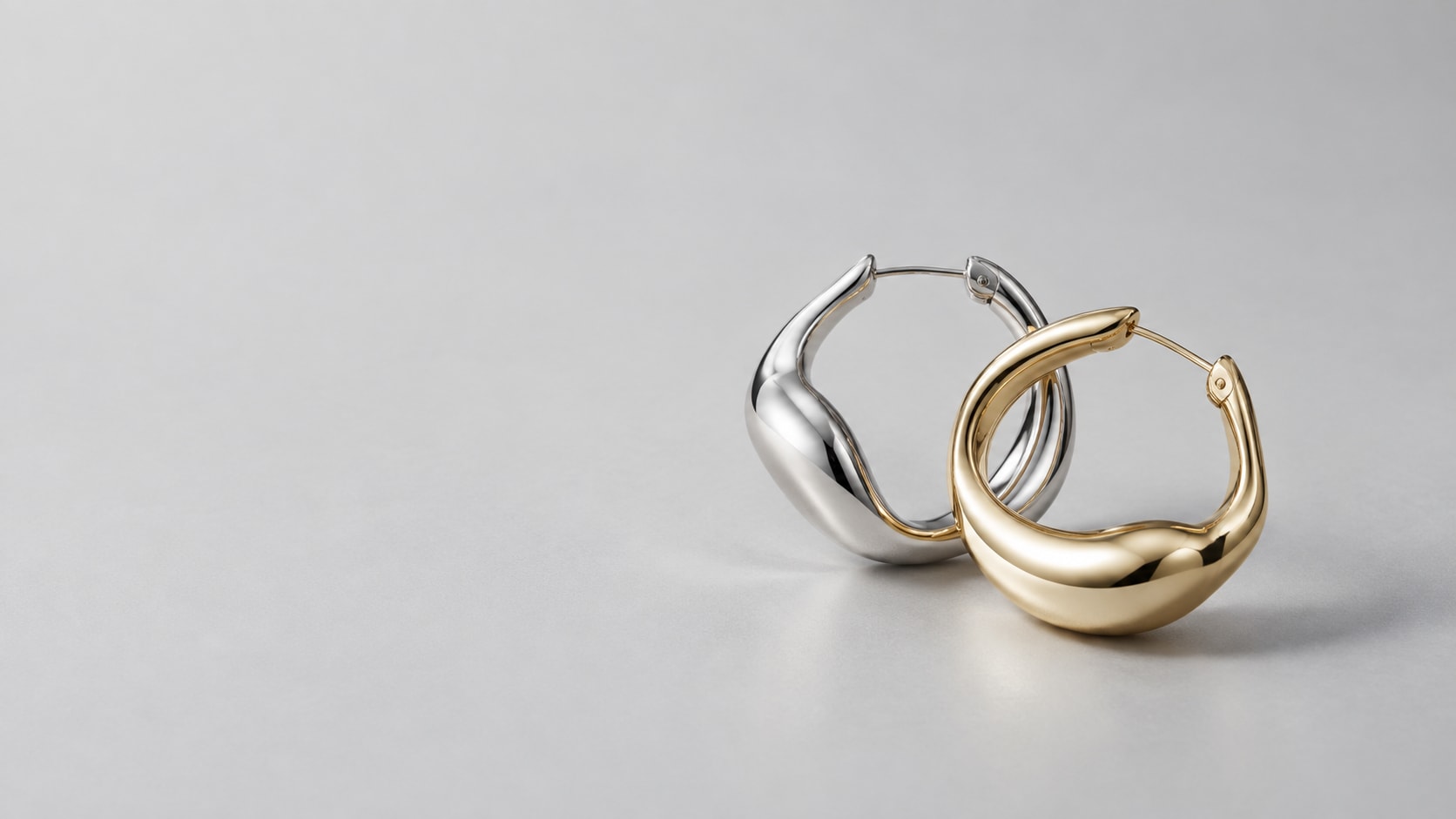 Sculptural silver and gold-tone earrings